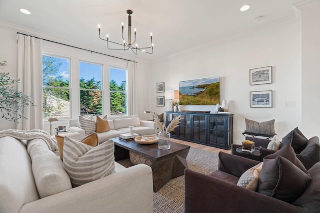 living room with crown molding, wood-type flooring, and an inviting chandelier