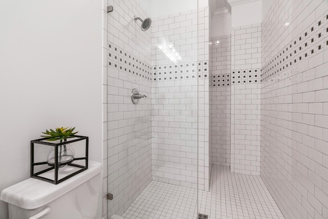 bathroom featuring tiled shower and toilet