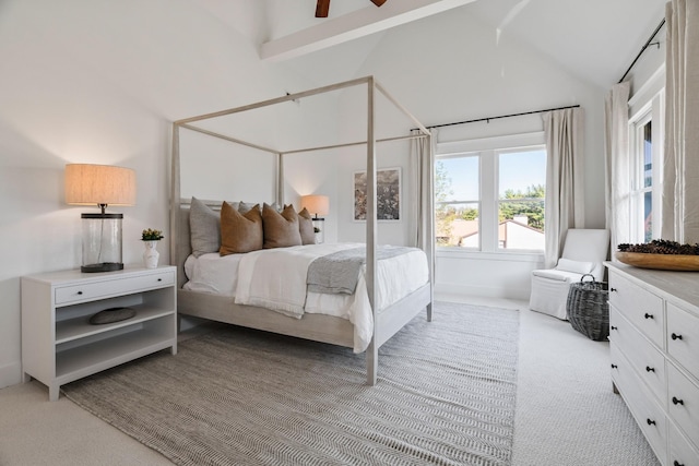 carpeted bedroom with high vaulted ceiling