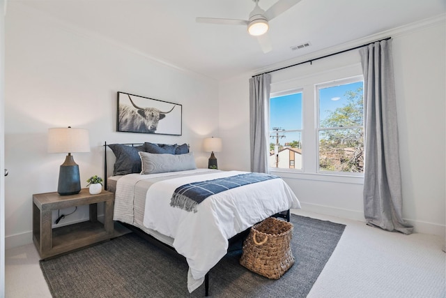 carpeted bedroom featuring ceiling fan and ornamental molding