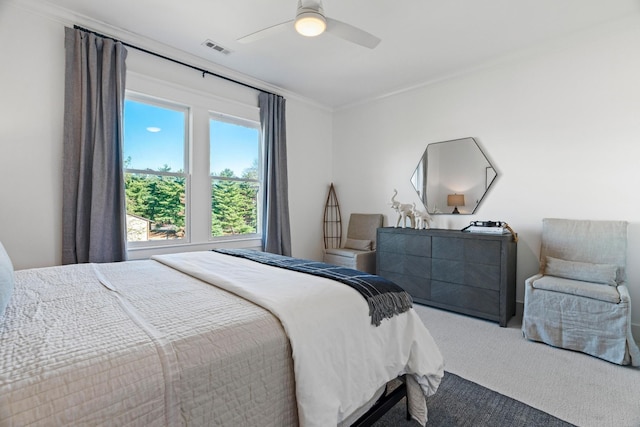 bedroom featuring crown molding, ceiling fan, and carpet floors