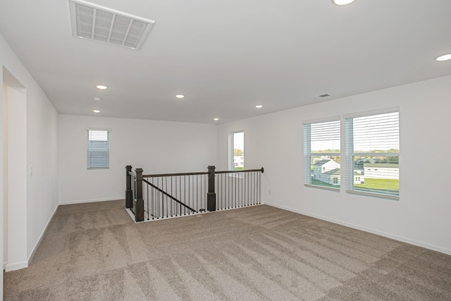 spare room featuring light colored carpet