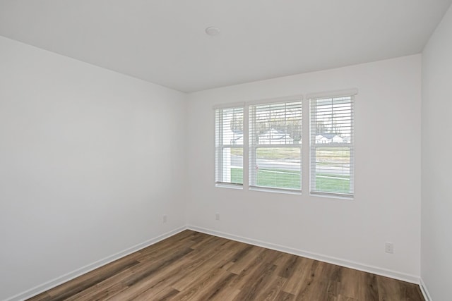 empty room with dark wood-type flooring