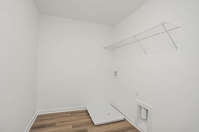 washroom with hardwood / wood-style flooring, washer hookup, and electric dryer hookup