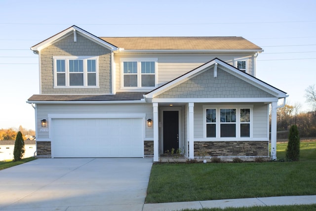 craftsman inspired home with a garage and a front yard