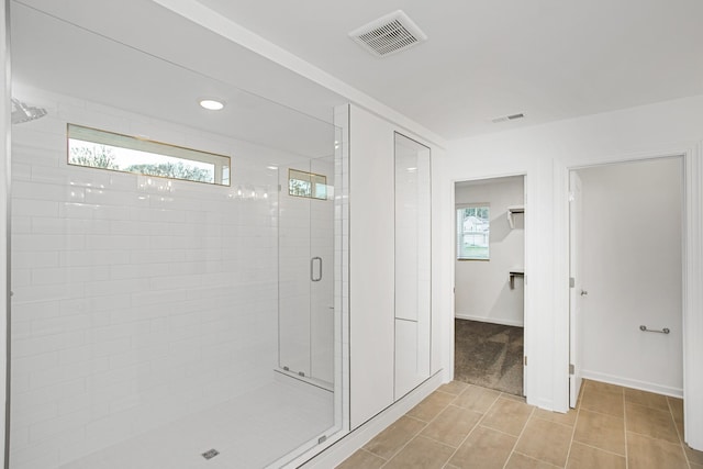 bathroom featuring plenty of natural light, an enclosed shower, and tile patterned floors