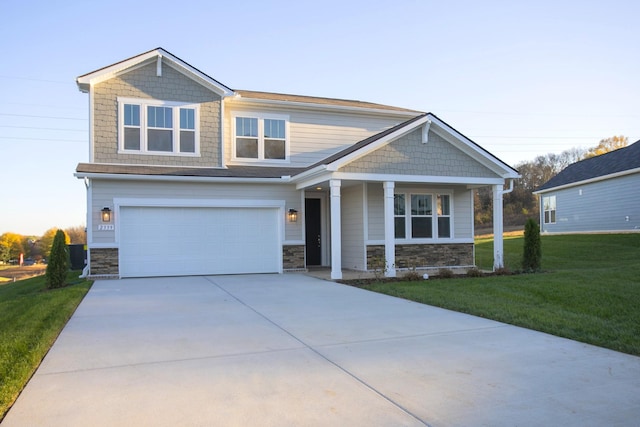 craftsman-style house with a garage and a front lawn