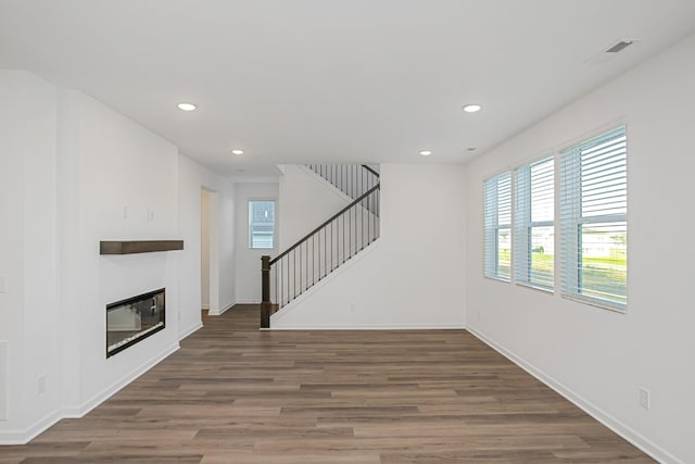 unfurnished living room with dark hardwood / wood-style floors