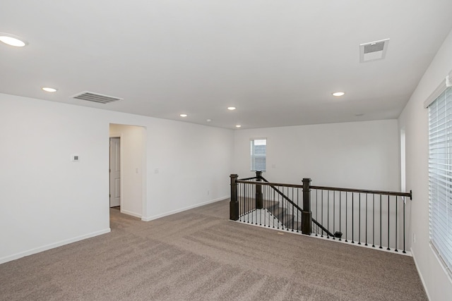 empty room featuring light carpet