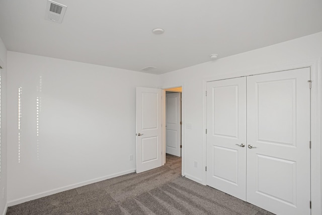 unfurnished bedroom featuring carpet flooring and a closet