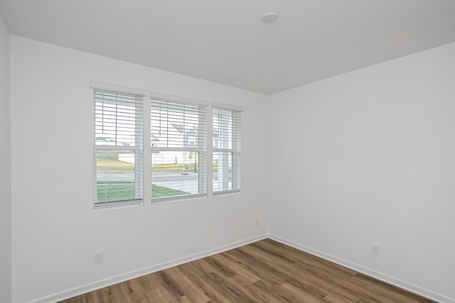 spare room with hardwood / wood-style floors