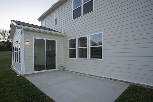 back of property with a patio area and a lawn