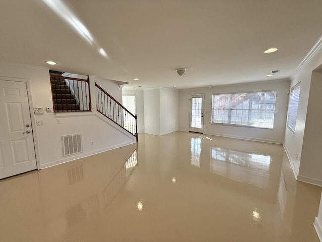 unfurnished living room featuring ornamental molding