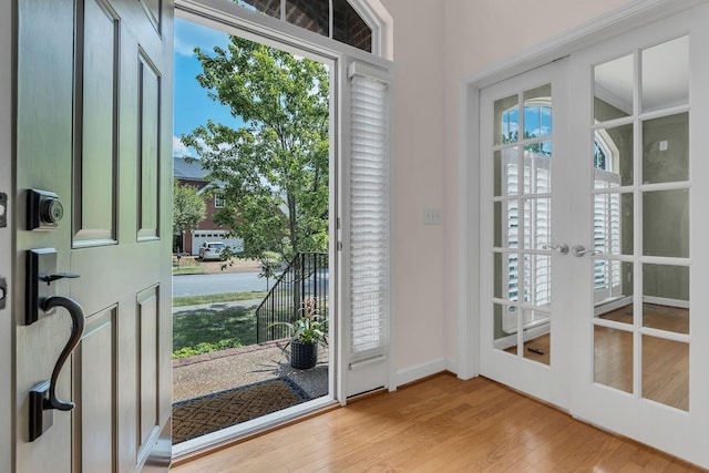 doorway with light hardwood / wood-style flooring and french doors