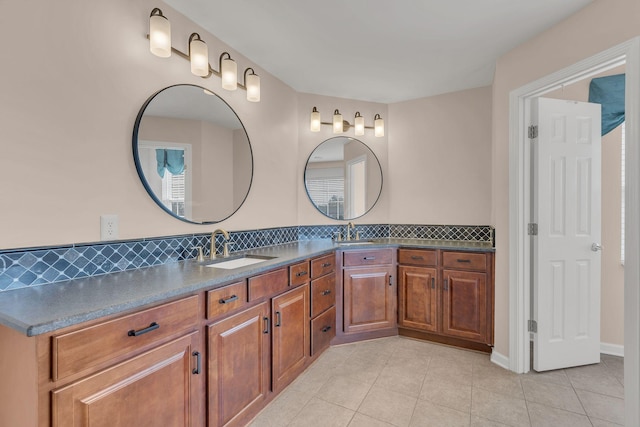 bathroom featuring tile patterned flooring, vanity, and decorative backsplash