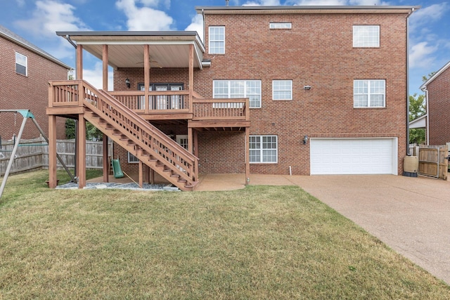 back of house with a garage, a deck, and a lawn