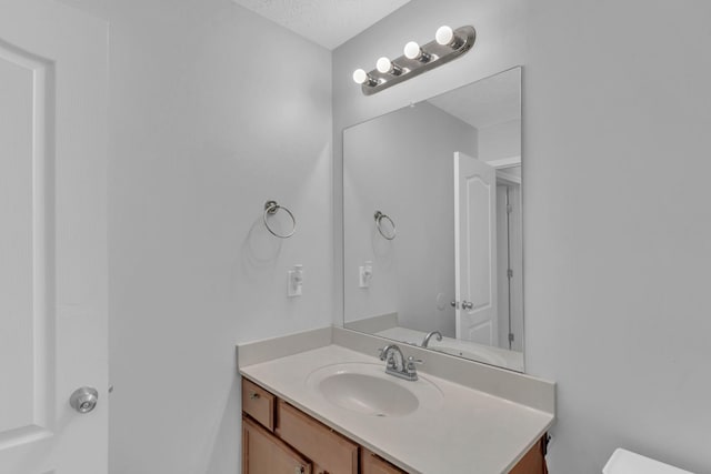 bathroom with vanity and a textured ceiling