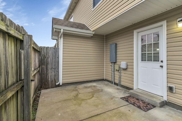 view of exterior entry featuring a patio area