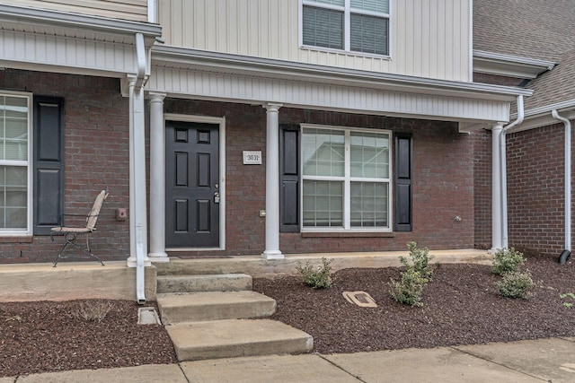 view of exterior entry featuring a porch