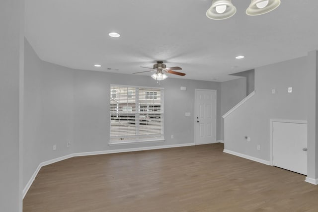 unfurnished living room with ceiling fan and wood-type flooring