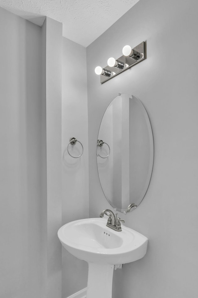 bathroom with sink and a textured ceiling