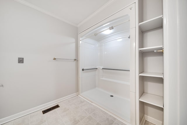 bathroom with ornamental molding and a shower