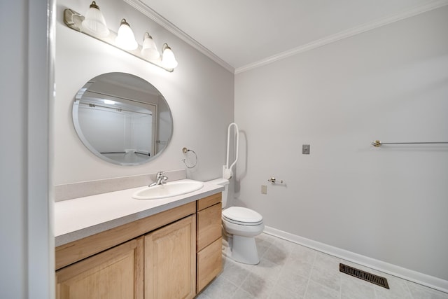 bathroom with vanity, crown molding, and toilet