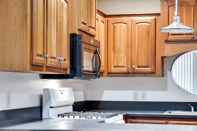 kitchen featuring sink and white range with gas stovetop