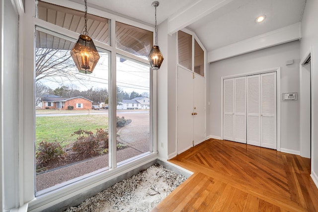 foyer entrance featuring parquet flooring and a healthy amount of sunlight