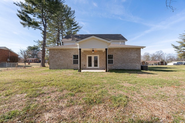 rear view of property featuring ceiling fan, a yard, central AC unit, a patio area, and french doors