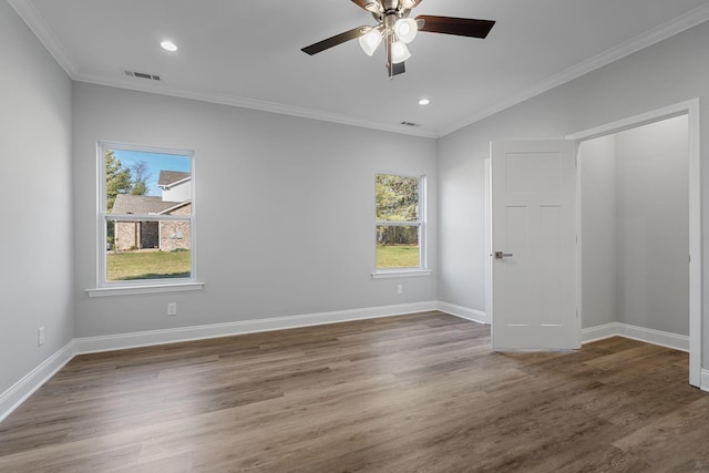 empty room featuring crown molding, dark hardwood / wood-style floors, and ceiling fan