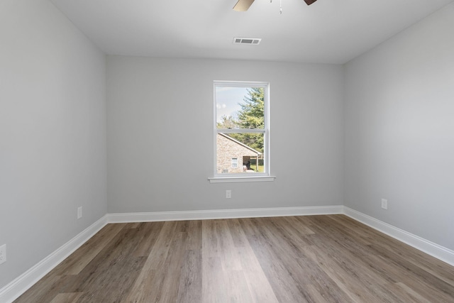 empty room featuring hardwood / wood-style flooring and ceiling fan