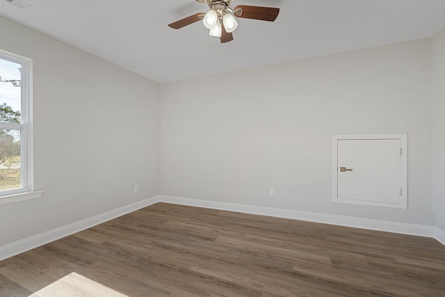 spare room with ceiling fan, dark hardwood / wood-style flooring, and vaulted ceiling