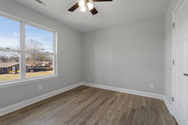 unfurnished room featuring ceiling fan and dark hardwood / wood-style flooring