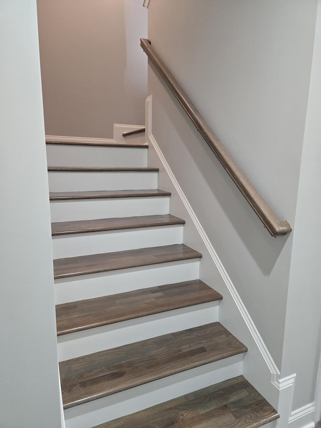 stairway with hardwood / wood-style floors