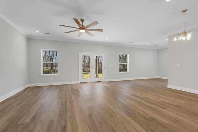 spare room featuring hardwood / wood-style flooring, ceiling fan, crown molding, and french doors