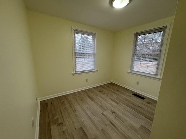 empty room with light hardwood / wood-style flooring