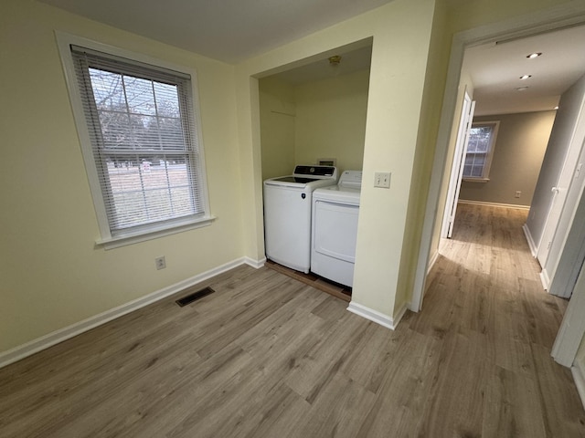 washroom featuring light wood-type flooring and independent washer and dryer