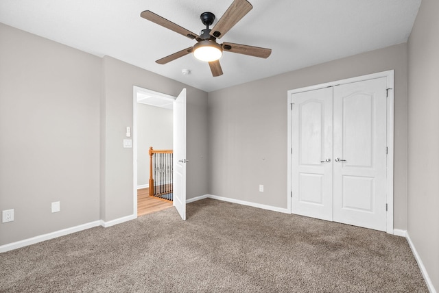 unfurnished bedroom with light carpet, ceiling fan, and a closet