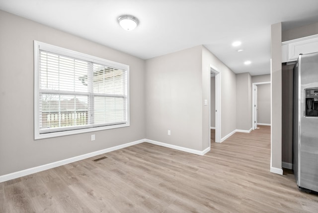 spare room featuring light hardwood / wood-style flooring