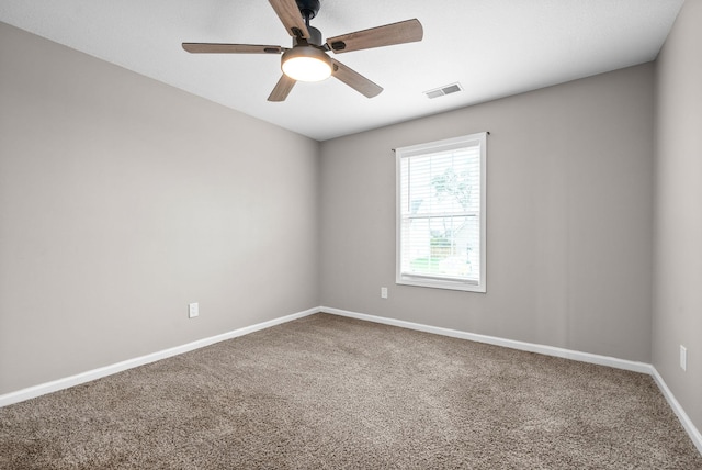 spare room with carpet floors and ceiling fan