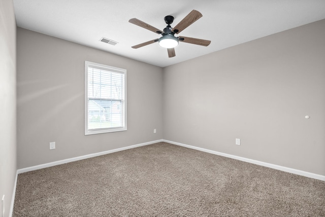 unfurnished room with ceiling fan and carpet