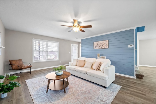 living room with dark wood-type flooring and ceiling fan