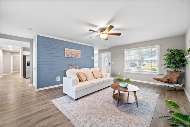 living room featuring ceiling fan and hardwood / wood-style floors