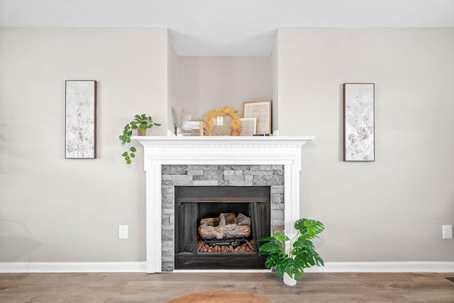 interior details with wood-type flooring and a fireplace