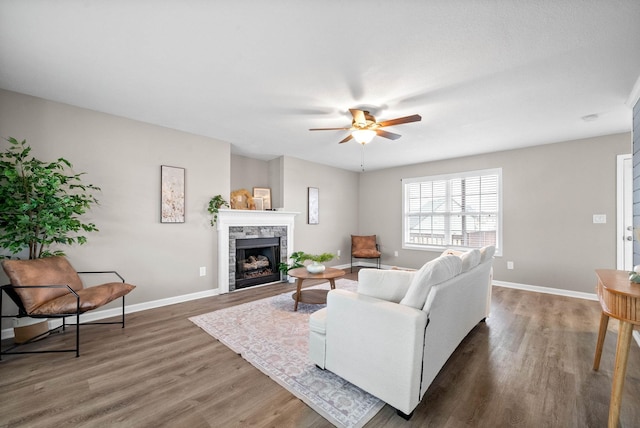 living room featuring dark hardwood / wood-style floors and ceiling fan