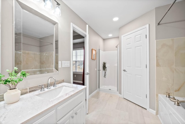 bathroom featuring vanity and separate shower and tub