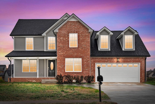 view of front of property featuring a garage and a yard