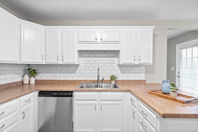 kitchen with stainless steel dishwasher, sink, decorative backsplash, and white cabinets