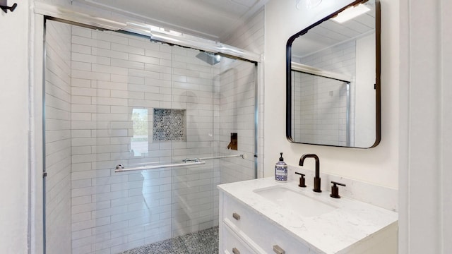 bathroom featuring vanity and an enclosed shower